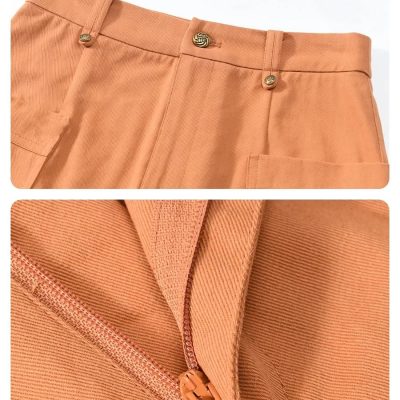 Close-up of peach-colored tailored pants featuring a zipper detail and fine stitching, showcasing high-quality fabric and craftsmanship for fashionable, comfortable wear.