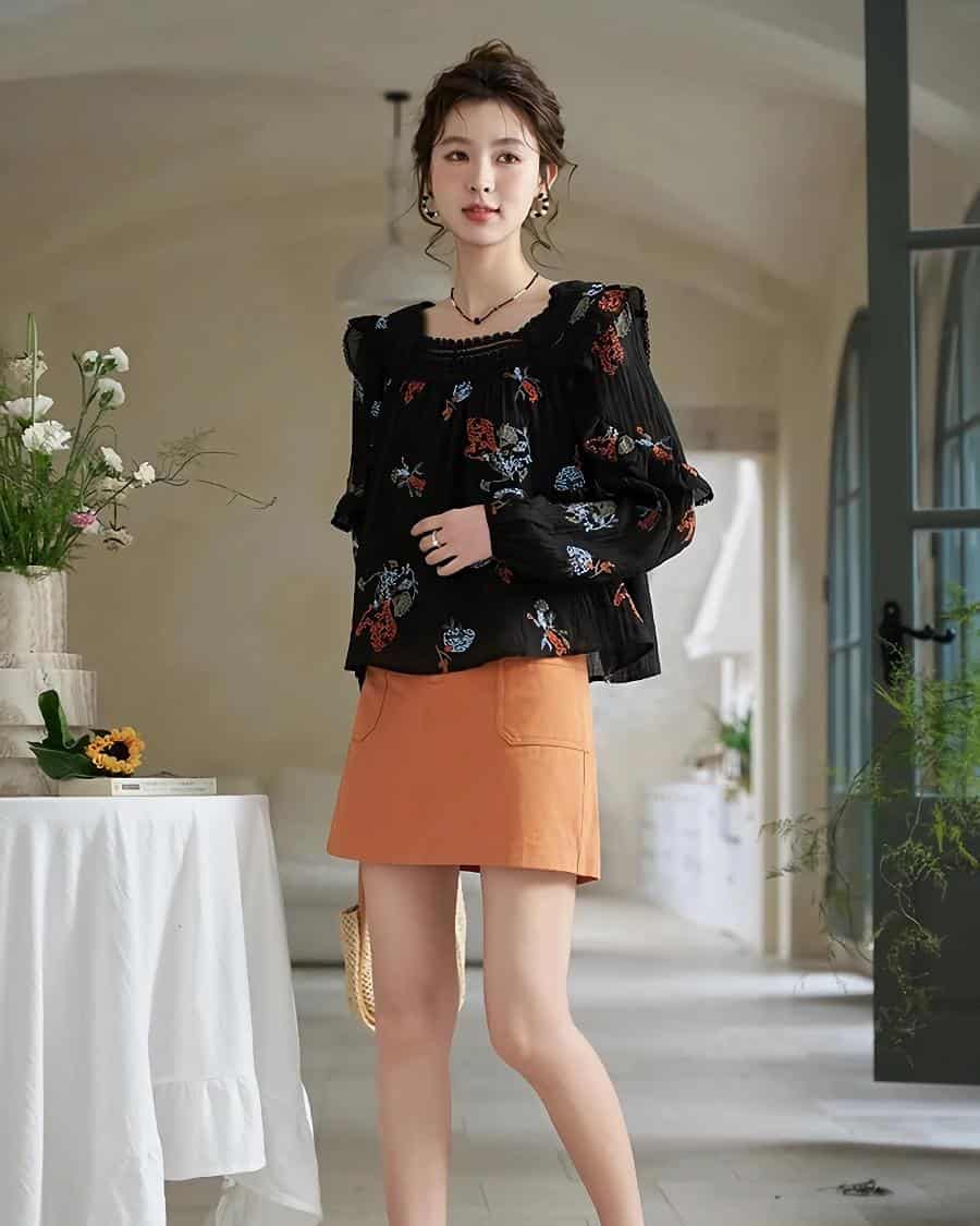 Elegant floral blouse and stylish orange skirt for women at Monalisa Medical Store.