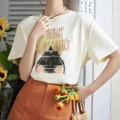 Stylish casual beige t-shirt featuring a camera illustration and