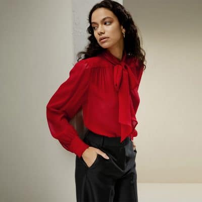 Elegant red blouse with bow tie neck, ideal for office and formal wear. Made with high-quality fabric for a sophisticated look and comfortable fit. Perfect for professional and stylish appearances.