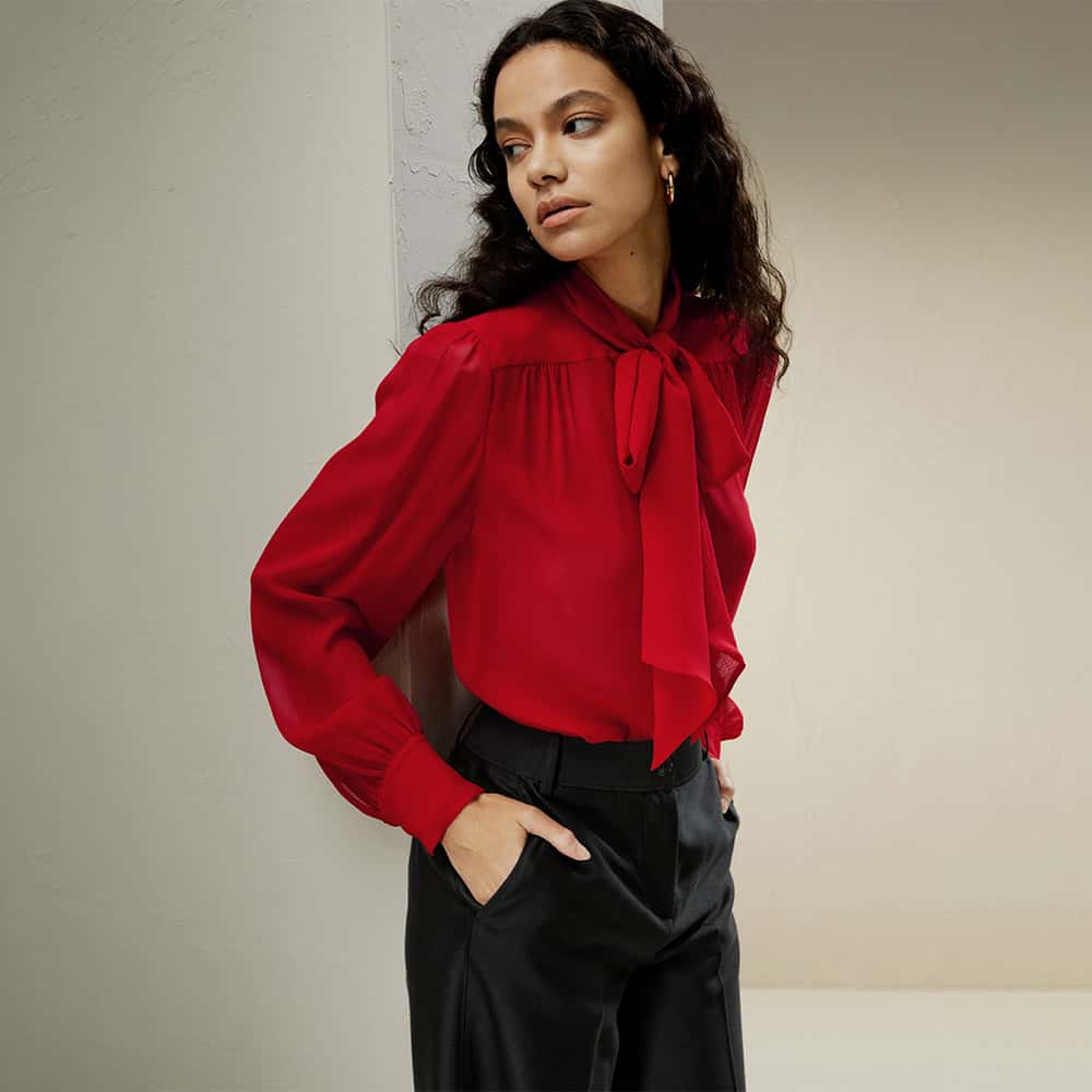 Elegant red blouse with bow tie neck, ideal for office and formal wear. Made with high-quality fabric for a sophisticated look and comfortable fit. Perfect for professional and stylish appearances.