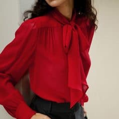 Fashionable women's red blouse featuring a stylish bow tie neckline and long sleeves, perfect for office wear or social occasions. Crafted for comfort and elegance.