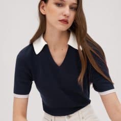 Women's stylish navy blue sweater with white collar and cuffs, perfect for fashion-forward and professional looks.