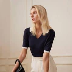 Chic woman with stylish glasses and sophisticated outfit at Monalisa Store, offering premium eyewear and optometry services for all ages.