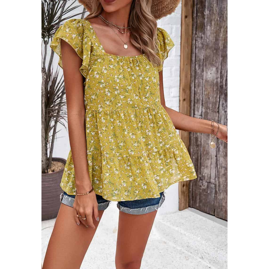 Elegant women's yellow floral tunic top with ruffled sleeves, perfect for summer and casual outings. Made from lightweight, breathable fabric to keep you comfortable while looking stylish.