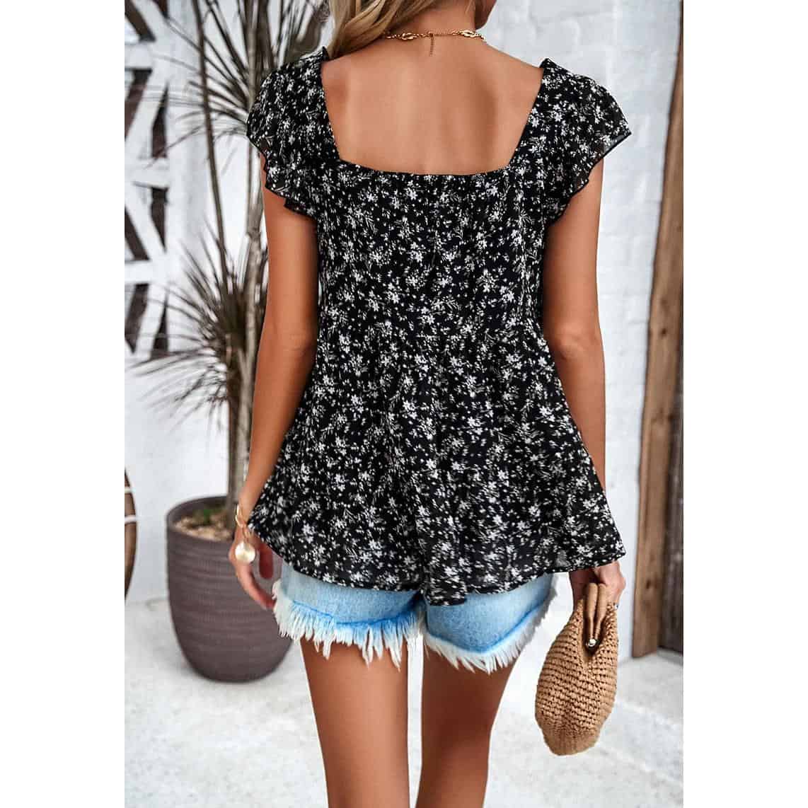 Elegant black floral blouse with ruffled sleeves, perfect for summer fashion and casual outings.