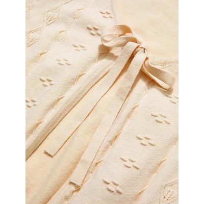 Soft pastel-colored baby blanket with textured patterns and tied ribbons for comfortable use and stylish baby care. Perfect for naps and cuddles.