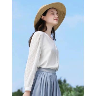 Elegant sunhat and stylish clothing for sun protection and outdoor fashion.