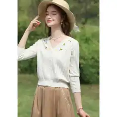 Light-colored wide-brim sun hat perfect for outdoor occasions.