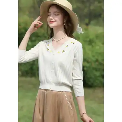 Light-colored wide-brim sun hat perfect for outdoor occasions.