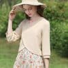 Elegant beige women's blouse with chic three-quarter sleeves, perfect for spring and summer wear. Paired with a floral skirt, ideal for casual outings, outdoor events, or stylish everyday looks.