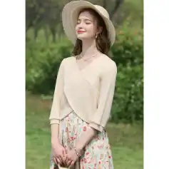 Beautiful woman wearing summer hat, casual dress, and jewelry outdoors, showcasing trendy summer fashion and accessories perfect for warm weather.