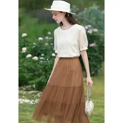Stylish women’s dress with a flowy brown skirt and cream blouse, perfect for summer outings and casual wear.