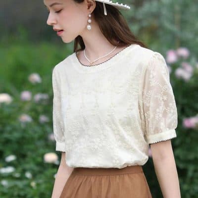 Stylish white lace blouse with intricate embroidery for women, perfect for casual or office wear. Comfortable and fashionable, ideal for enhancing your wardrobe.