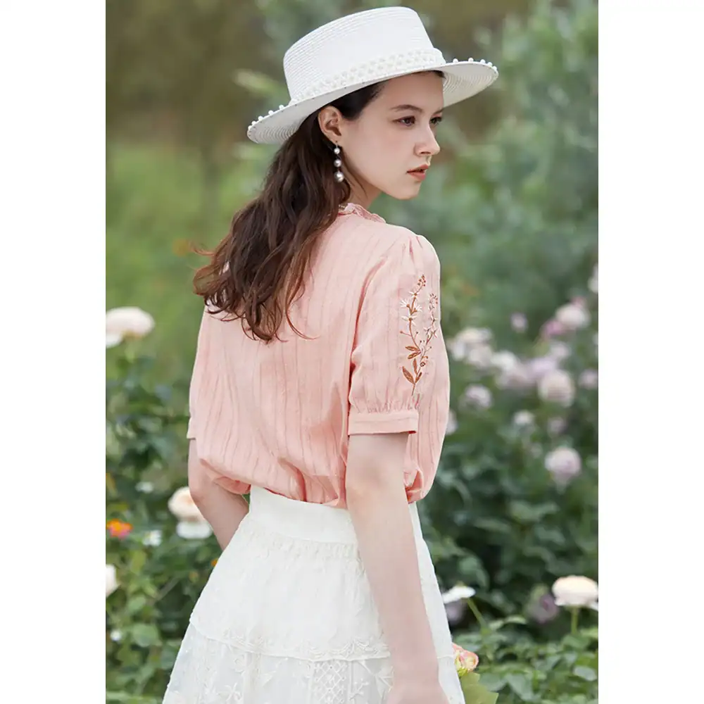 Stylish white summer hat with eyelet details paired with a soft pink embroidered blouse and a white lace skirt, perfect for women's fashion, outdoor, and beachwear.