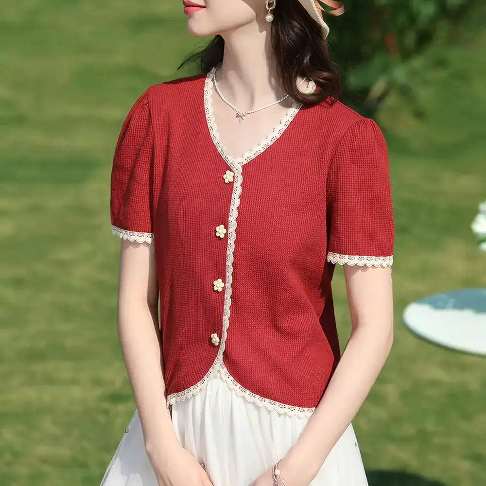 Red blouse with lace-edged neckline and sleeves, floral buttons, perfect for stylish women seeking trendy fashion.