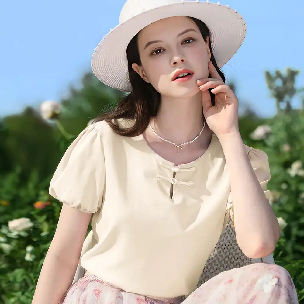 Stylish wide-brim hat and light-colored blouse for women, perfect for outdoor sun protection and summer fashion. Elegant accessories from Monalisa Store enhance your sunny-day outfits.