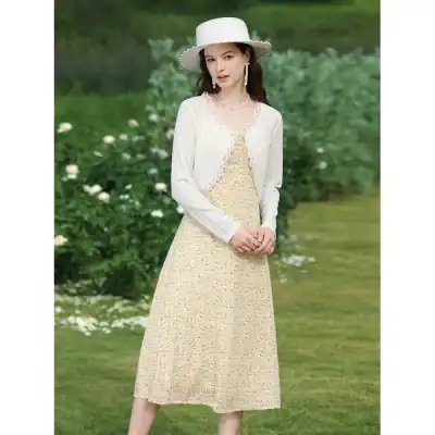 Women’s floral maxi dress with white cardigan, stylish hat, and jewelry, perfect for outdoor summer events and garden parties.