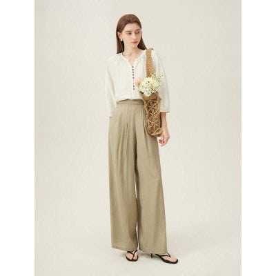 Stylish outfit featuring a white blouse and beige wide-leg trousers, perfect for casual or professional wear.