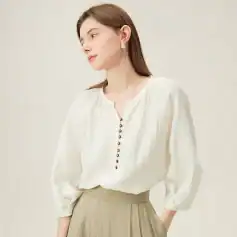 Image of a woman in a chic white blouse with beige pleated skirt, ideal for office fashion and trendy workwear.