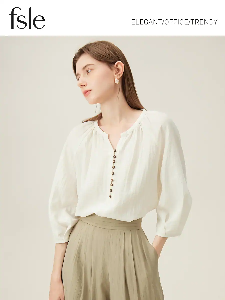 Image of a woman in a chic white blouse with beige pleated skirt, ideal for office fashion and trendy workwear.