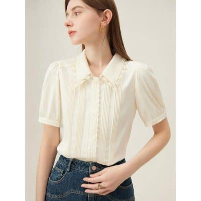 Stylish cream blouse with lace collar, short puff sleeves, and vertical stripe details, perfect for professional or casual wear.