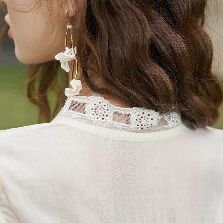 Close-up of a woman’s lace neckline with intricate embroidery and floral patterns, perfect for stylish and modern women's clothing accessories.