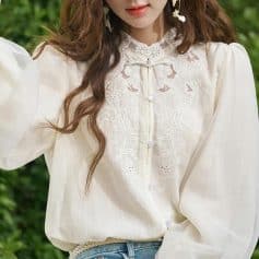 Stylish women's cream blouse with intricate lace embroidery, button-up front, and puff sleeves. Perfect for casual or semi-formal occasions, enhancing your fashion statement.