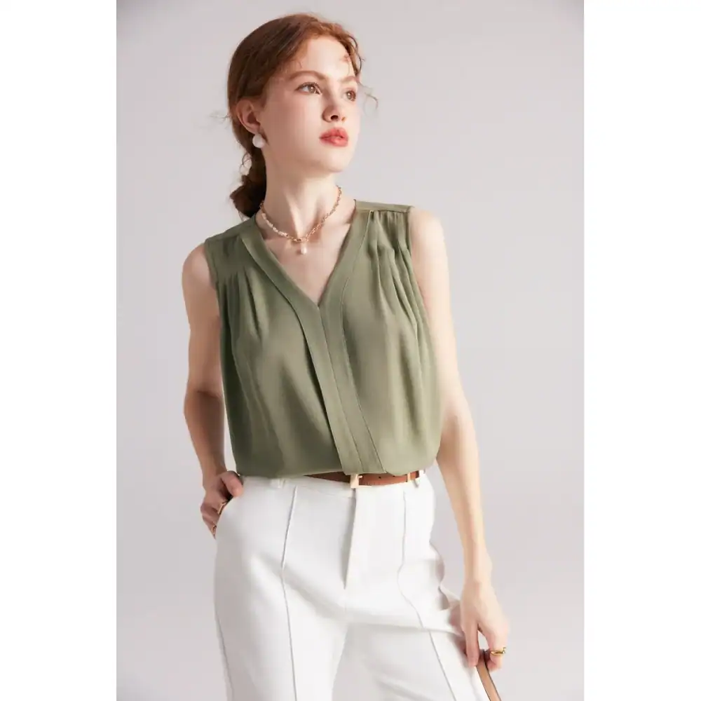 High-quality olive green sleeveless blouse perfect for modern women, suitable for office or casual wear, featuring stylish pleats and a V-neck design.