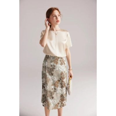 A stylish, floral print midi skirt perfect for professional or casual wear, featuring a blend of beige, brown, and white tones that complement any wardrobe.