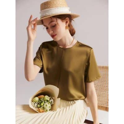 Stylish women's satin blouse in a shiny gold finish, perfect for special occasions. Featuring a round neckline and short sleeves, ideal for trendy and comfortable fashion statements.