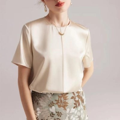 Luxurious satin blouse with pearl accents, perfect for sophisticated occasions and office wear. Designed for style and comfort, making it an essential addition to your wardrobe.
