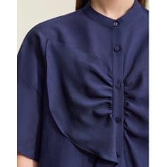High-Quality Blue Women's Medical Scrub Top with Unique Ruffled Design, Comfortable Fit, and Durable Fabric for Healthcare Professionals.