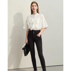 Stylish woman wearing a white blouse and black high-waisted pants, perfect for business or casual wear.