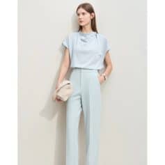 Elegant light blue women's formal suit with matching tailored trousers and a chic top, perfect for professional and stylish occasions.