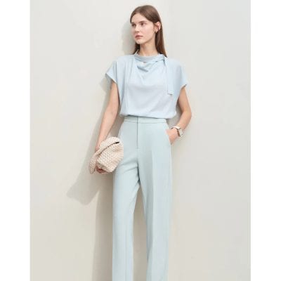 Elegant light blue women's formal suit with matching tailored trousers and a chic top, perfect for professional and stylish occasions.