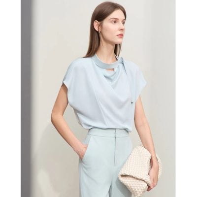 An elegant light blue women's blouse with a stylish draped neckline, perfect for business or casual wear, showcased at Monalisa Store for a chic and modern look.