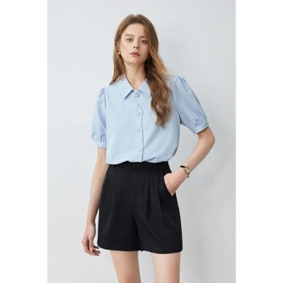 Elegant light blue women's blouse with puff sleeves, perfect for office or casual wear. Made from comfortable, high-quality fabric for a stylish and comfortable fit.