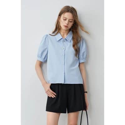 Elegant women’s blue blouse with puff sleeves and button-up design, perfect for casual and office wear. High-quality fabric, stylish and comfortable.