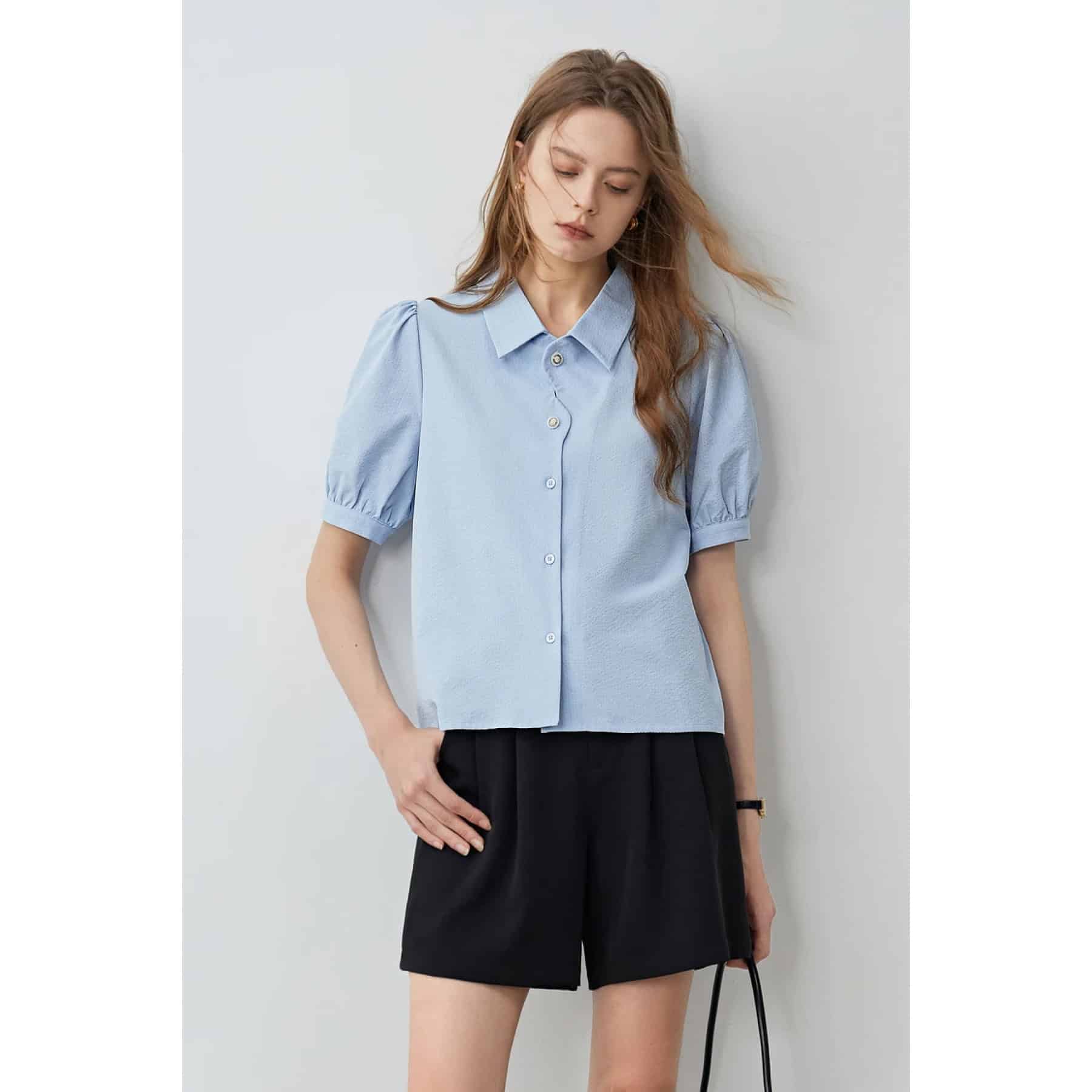 Elegant women’s blue blouse with puff sleeves and button-up design, perfect for casual and office wear. High-quality fabric, stylish and comfortable.