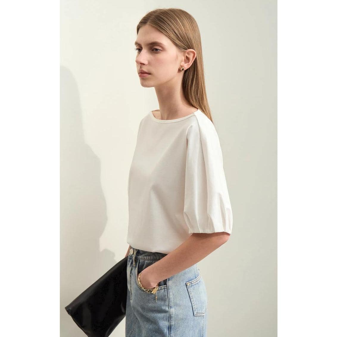 Stylish women's white blouse with puff sleeves, perfect for professional or casual wear. Made from quality fabric, offering comfort and trendy fashion appeal.