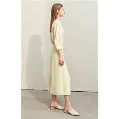 Stylish woman wearing a cream dress from Monalisa Store, showcasing elegant fashion and comfortable clothing for modern women.