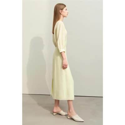 Stylish woman wearing a cream dress from Monalisa Store, showcasing elegant fashion and comfortable clothing for modern women.