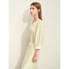 Young woman wearing stylish, elegant light yellow dress perfect for optical and eyewear fashion at Monalisa Store.