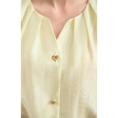 Optometry store fashion blouse, stylish blouse with gold button accents, perfect for optical shop staff or optometrists, trendy professional eyewear store outfit, Monalisa Medical branding.