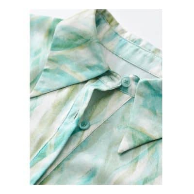 Watercolor floral blouse featuring soft pastel shades and lightweight fabric, ideal for stylish, comfortable women's wear. Perfect for casual or semi-formal occasions.