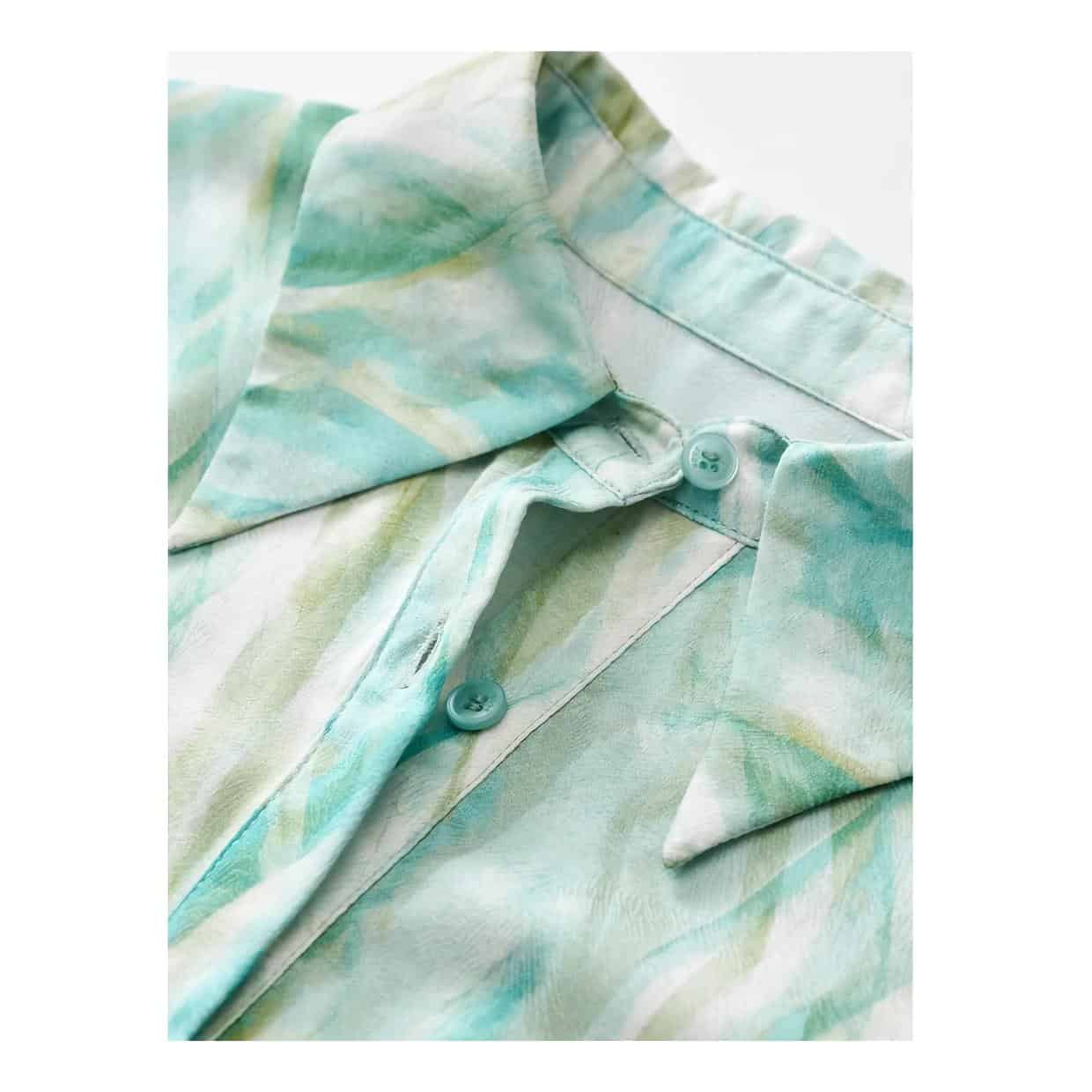 Watercolor floral blouse featuring soft pastel shades and lightweight fabric, ideal for stylish, comfortable women's wear. Perfect for casual or semi-formal occasions.
