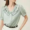 Elegant embroidered blouse with scalloped collar and puff sleeves, ideal for women's fashion, stylish, and versatile for various outfits and occasions.