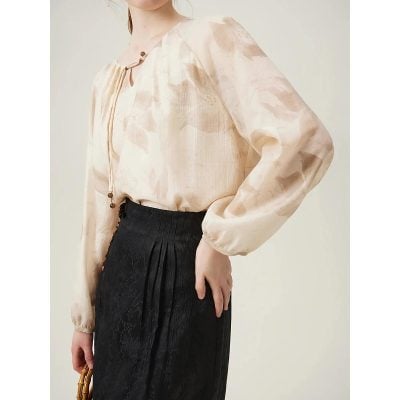 A stylish, beige women's blouse featuring a lightweight, silky fabric with a subtle print, perfect for professional or casual wear, offering comfort and chic fashion statement.