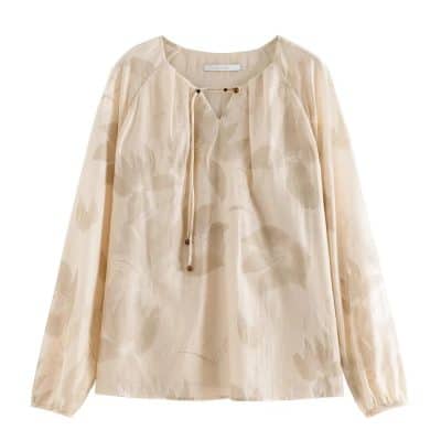 Women’s stylish blouse in neutral beige tones, perfect for office wear or casual outings, featuring a sophisticated cut, lightweight fabric, and modern details.